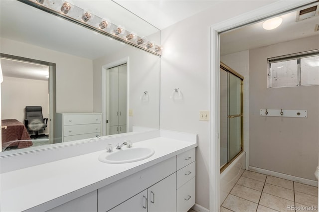 full bathroom with combined bath / shower with glass door, vanity, tile patterned floors, and toilet