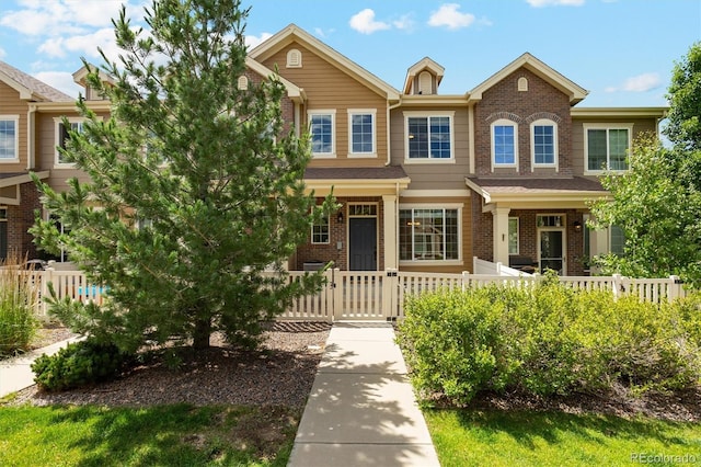 16062 W 62nd Ln, Arvada, CO 80403 - view of front of property with brick siding, a fenced front yard, and a gate