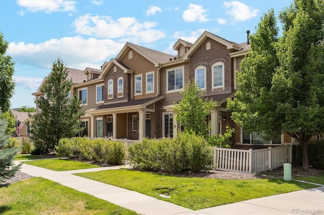 16062 W 62nd Ln, Arvada, CO 80403 - view of front of property featuring covered porch, a front lawn, and brick siding