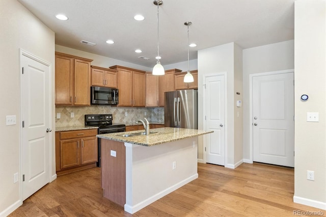 16062 W 62nd Ln, Arvada, CO 80403 - kitchen featuring appliances with stainless steel finishes, light wood-type flooring, backsplash, brown cabinets, and light stone counters