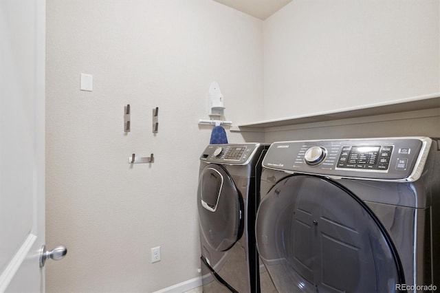 16062 W 62nd Ln, Arvada, CO 80403 - laundry area with washer and clothes dryer and baseboards