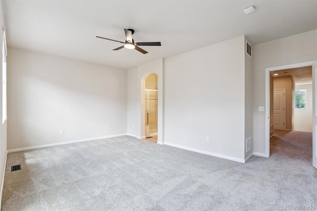 16062 W 62nd Ln, Arvada, CO 80403 - unfurnished bedroom featuring arched walkways, carpet, ceiling fan, and ensuite bathroom