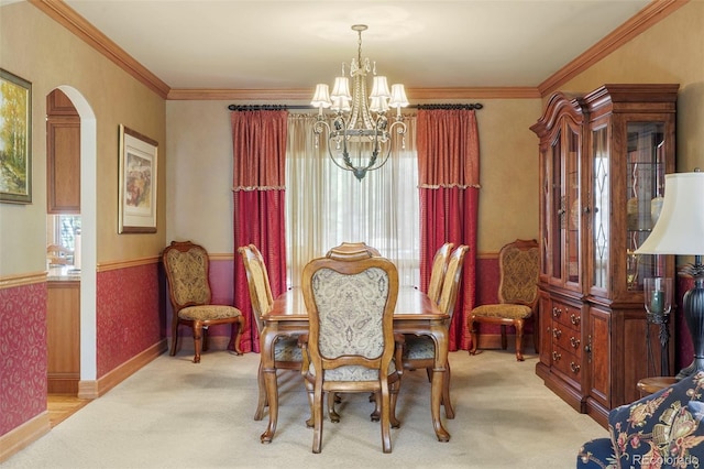 20050 Lost Arrowhead Dr, Monument, CO 80132 - dining space with a chandelier, healthy amount of natural light, arched walkways, carpet floors, and ornamental molding