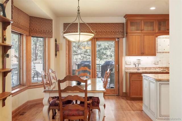 20050 Lost Arrowhead Dr, Monument, CO 80132 - dining area featuring light wood finished floors, healthy amount of natural light, baseboards, and recessed lighting