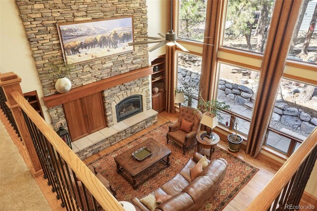 20050 Lost Arrowhead Dr, Monument, CO 80132 - living room featuring plenty of natural light, a stone fireplace, and wood finished floors