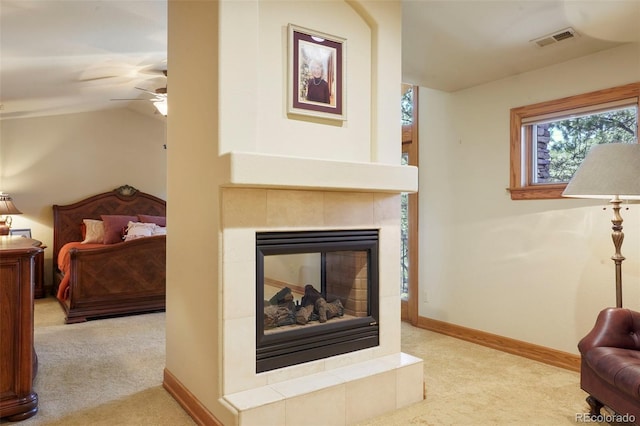 20050 Lost Arrowhead Dr, Monument, CO 80132 - living room with carpet floors, ceiling fan, baseboards, vaulted ceiling, and a tiled fireplace