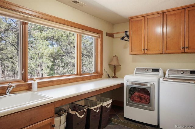 20050 Lost Arrowhead Dr, Monument, CO 80132 - clothes washing area featuring cabinet space, washer and clothes dryer, and dark tile patterned floors