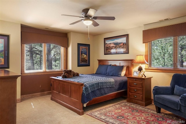 20050 Lost Arrowhead Dr, Monument, CO 80132 - bedroom featuring multiple windows, light colored carpet, baseboards, and a ceiling fan