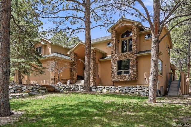 20050 Lost Arrowhead Dr, Monument, CO 80132 - back of house with stucco siding, stairs, a yard, and a balcony