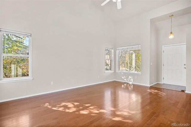 interior space featuring high vaulted ceiling, wood-type flooring, and ceiling fan