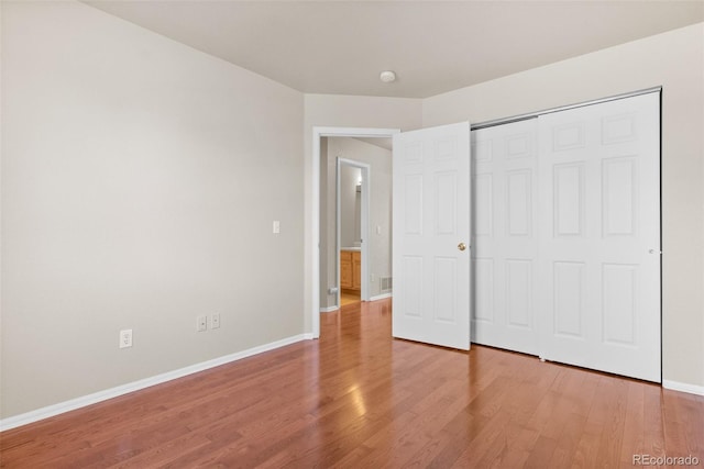 unfurnished bedroom featuring a closet and wood-type flooring