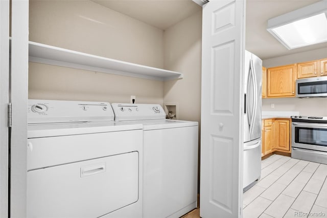 clothes washing area featuring separate washer and dryer