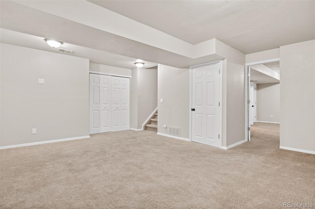 basement featuring light carpet