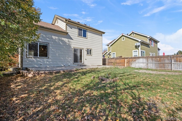 back of house featuring a lawn