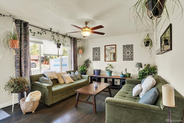 living room with dark hardwood / wood-style floors, ceiling fan, and a textured ceiling