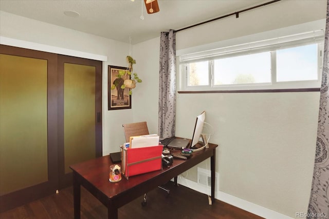 office space featuring ceiling fan and dark hardwood / wood-style flooring