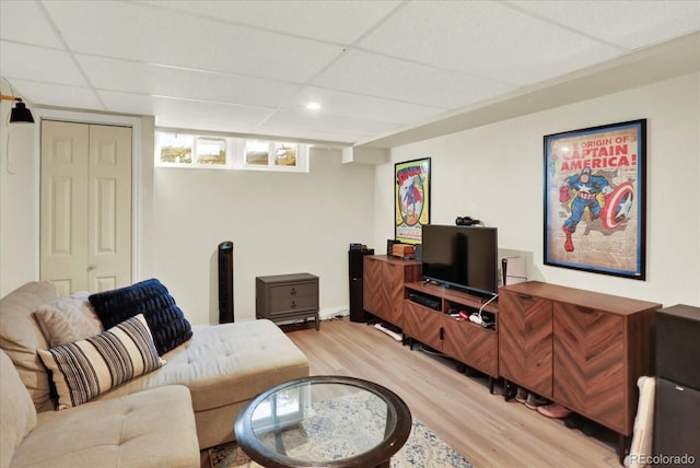 living room with a paneled ceiling and hardwood / wood-style flooring