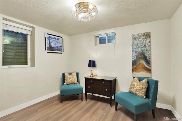 sitting room with light hardwood / wood-style flooring and a textured ceiling