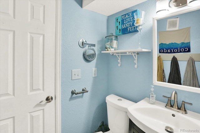 bathroom featuring toilet and sink