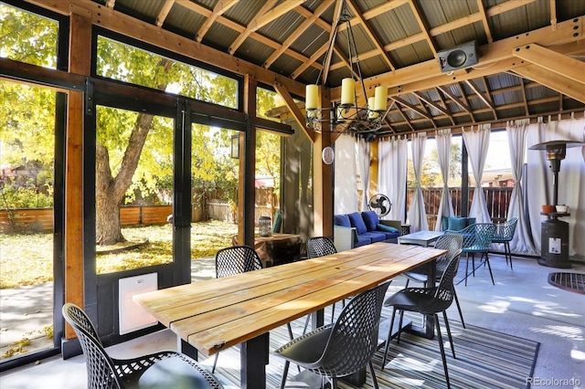 sunroom / solarium with an inviting chandelier and lofted ceiling