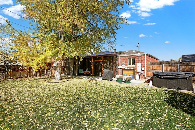 rear view of property with a lawn