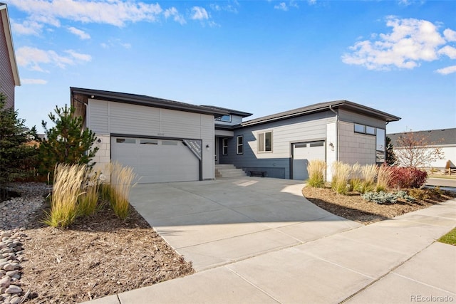 view of front facade with concrete driveway and an attached garage