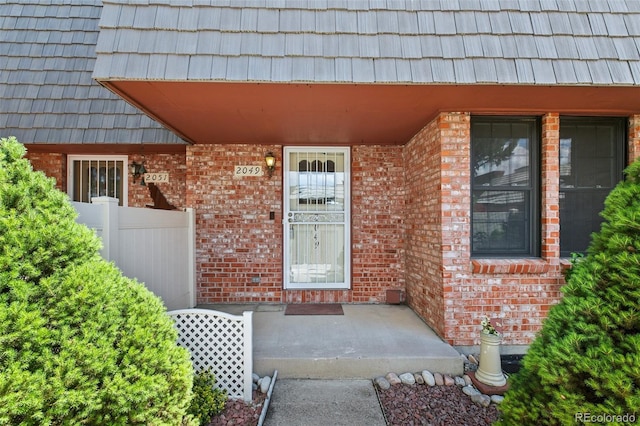 2049 Sussex Ln, Colorado Springs, CO 80909 - property entrance featuring brick siding