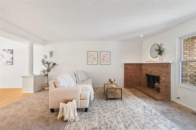 2049 Sussex Ln, Colorado Springs, CO 80909 - carpeted living room with a brick fireplace, a textured ceiling, and recessed lighting