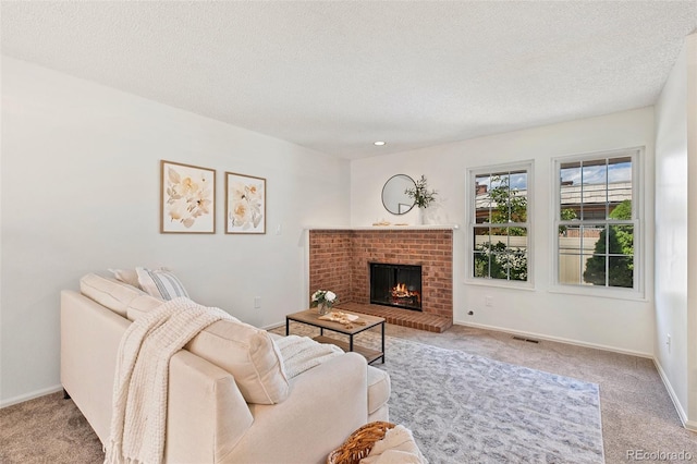 2049 Sussex Ln, Colorado Springs, CO 80909 - carpeted living room featuring a brick fireplace and a textured ceiling
