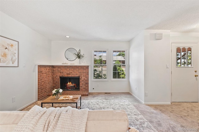 2049 Sussex Ln, Colorado Springs, CO 80909 - living area with a textured ceiling, carpet floors, and a brick fireplace