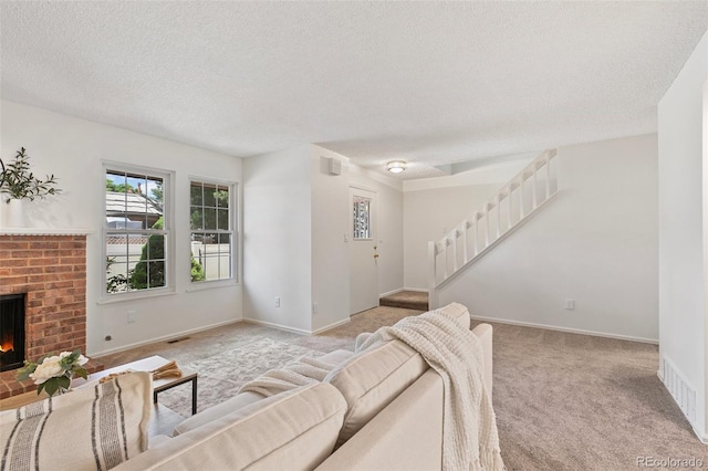 2049 Sussex Ln, Colorado Springs, CO 80909 - living area with carpet flooring, a textured ceiling, stairway, and a fireplace