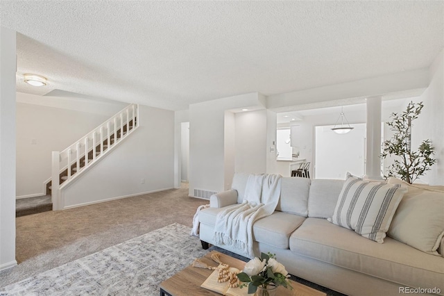 2049 Sussex Ln, Colorado Springs, CO 80909 - living area with carpet floors, stairs, and a textured ceiling