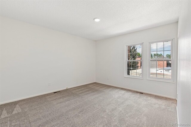 2049 Sussex Ln, Colorado Springs, CO 80909 - unfurnished room featuring carpet floors and a textured ceiling