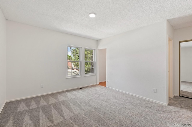 2049 Sussex Ln, Colorado Springs, CO 80909 - spare room featuring carpet flooring and a textured ceiling