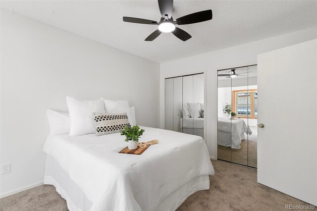 2049 Sussex Ln, Colorado Springs, CO 80909 - carpeted bedroom featuring multiple closets, a textured ceiling, and ceiling fan
