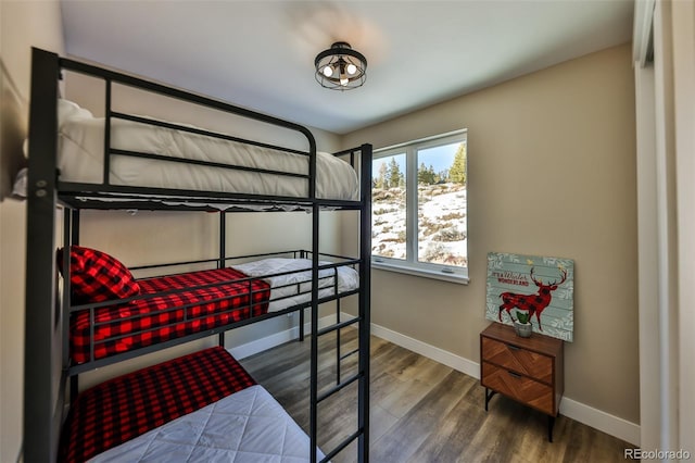 bedroom featuring baseboards and wood finished floors