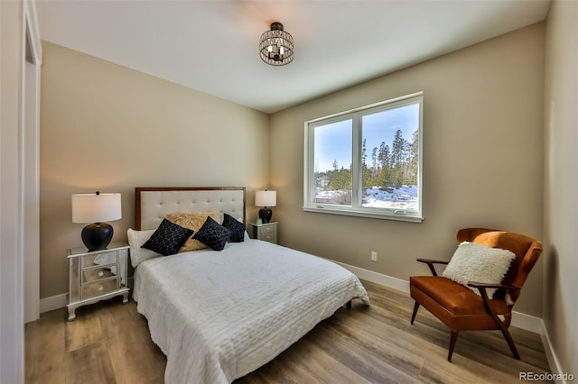 bedroom featuring baseboards and wood finished floors