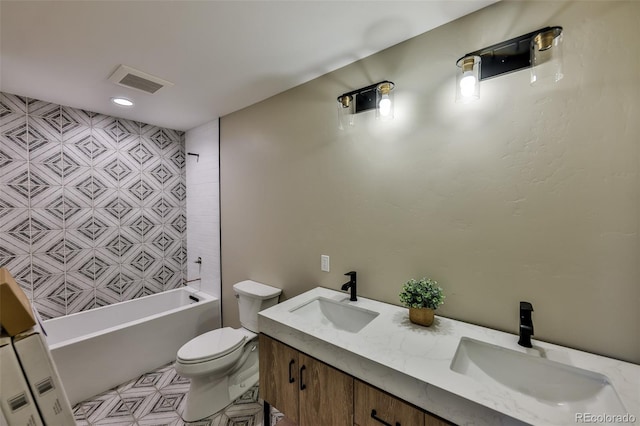 bathroom with visible vents, a sink, toilet, and double vanity