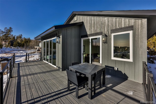 wooden deck featuring outdoor dining area