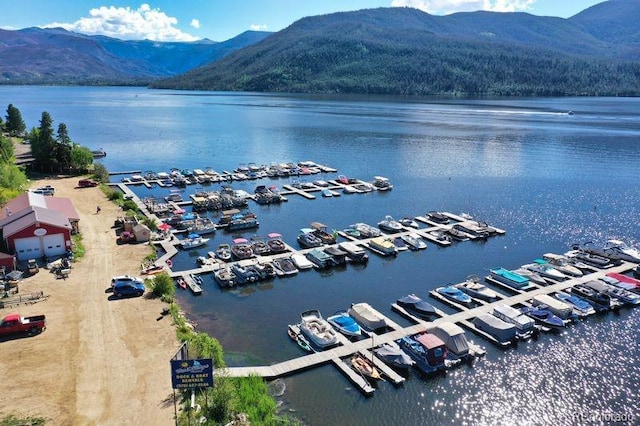 drone / aerial view featuring a water and mountain view