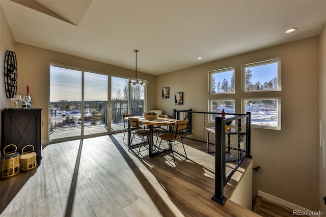 dining room featuring plenty of natural light, baseboards, and wood finished floors