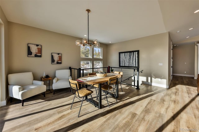 dining area with recessed lighting, an inviting chandelier, baseboards, and wood finished floors