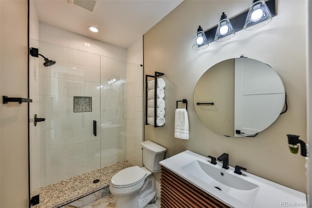 full bathroom with toilet, a stall shower, visible vents, and vanity