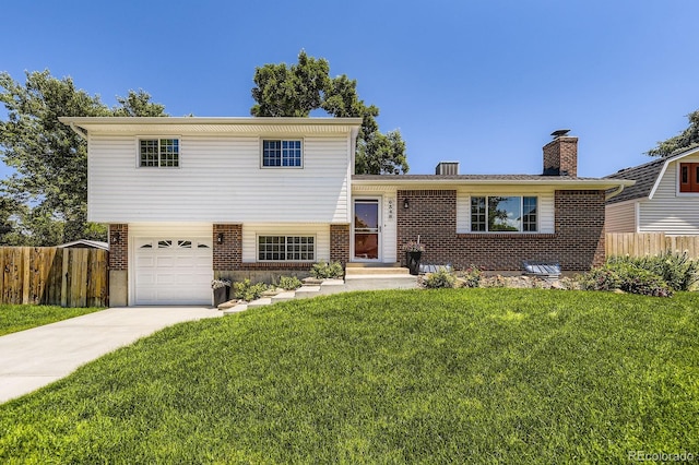 6348 S Independence St, Littleton, CO 80123 - split level home with brick siding, concrete driveway, a garage, and a chimney