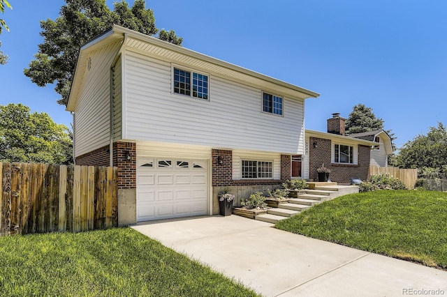 6348 S Independence St, Littleton, CO 80123 - split level home featuring brick siding, an attached garage, driveway, and a chimney