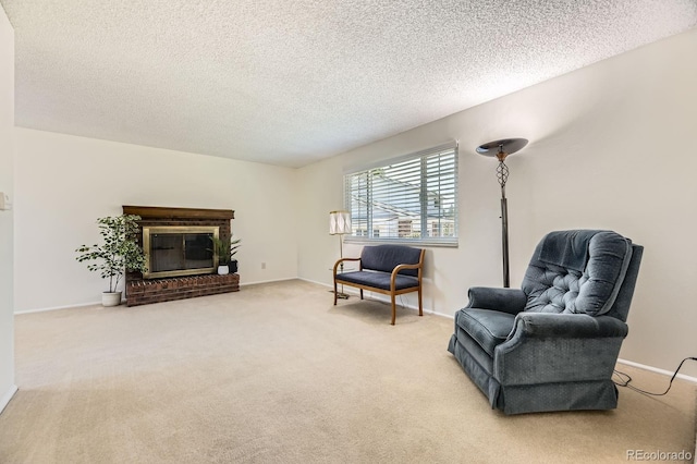 6348 S Independence St, Littleton, CO 80123 - sitting room featuring carpet floors, a textured ceiling, and a brick fireplace