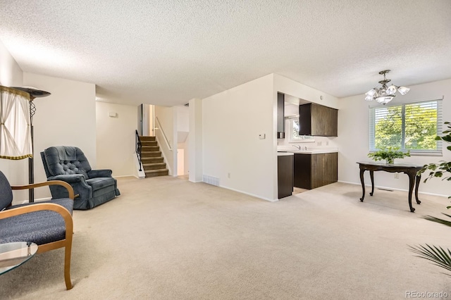 6348 S Independence St, Littleton, CO 80123 - sitting room featuring a textured ceiling, stairs, a chandelier, and light carpet