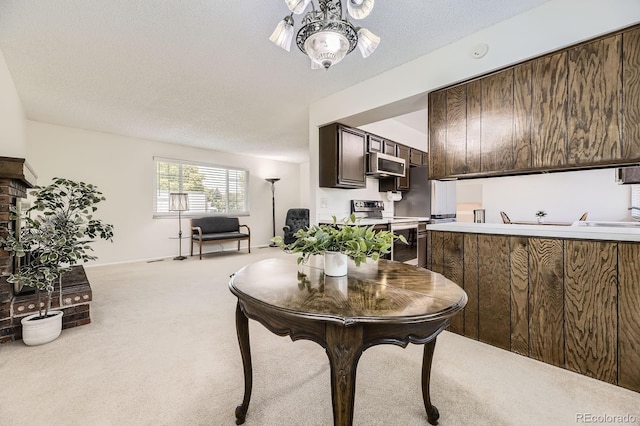 6348 S Independence St, Littleton, CO 80123 - kitchen featuring electric stove, light colored carpet, dark brown cabinetry, light countertops, and a textured ceiling