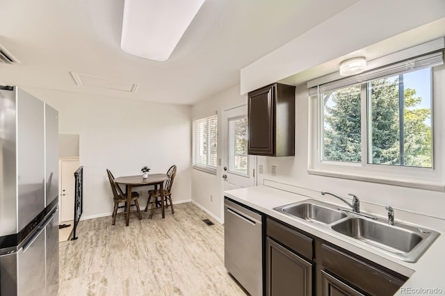 6348 S Independence St, Littleton, CO 80123 - kitchen featuring stainless steel appliances, dark brown cabinetry, plenty of natural light, and light countertops