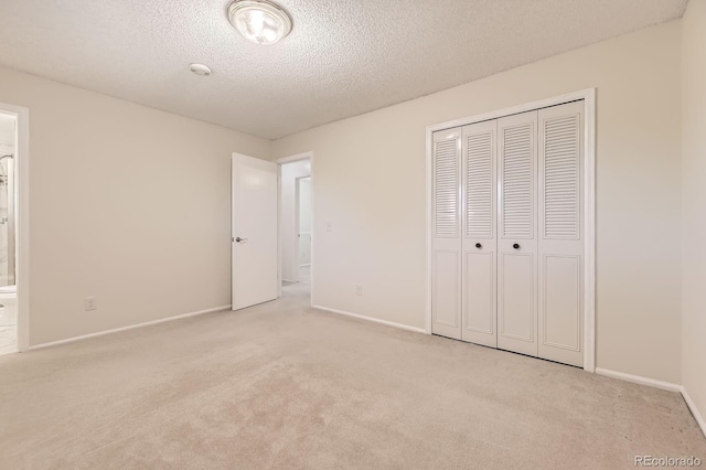 6348 S Independence St, Littleton, CO 80123 - unfurnished bedroom with carpet, a closet, a textured ceiling, and ensuite bathroom